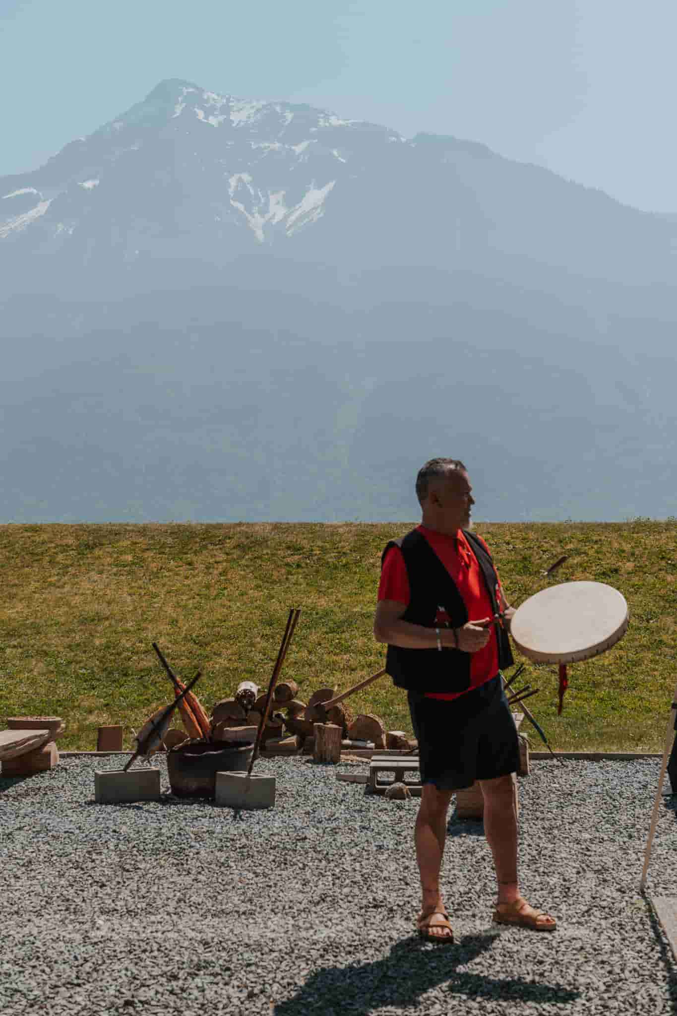 An indigenous man drumming 