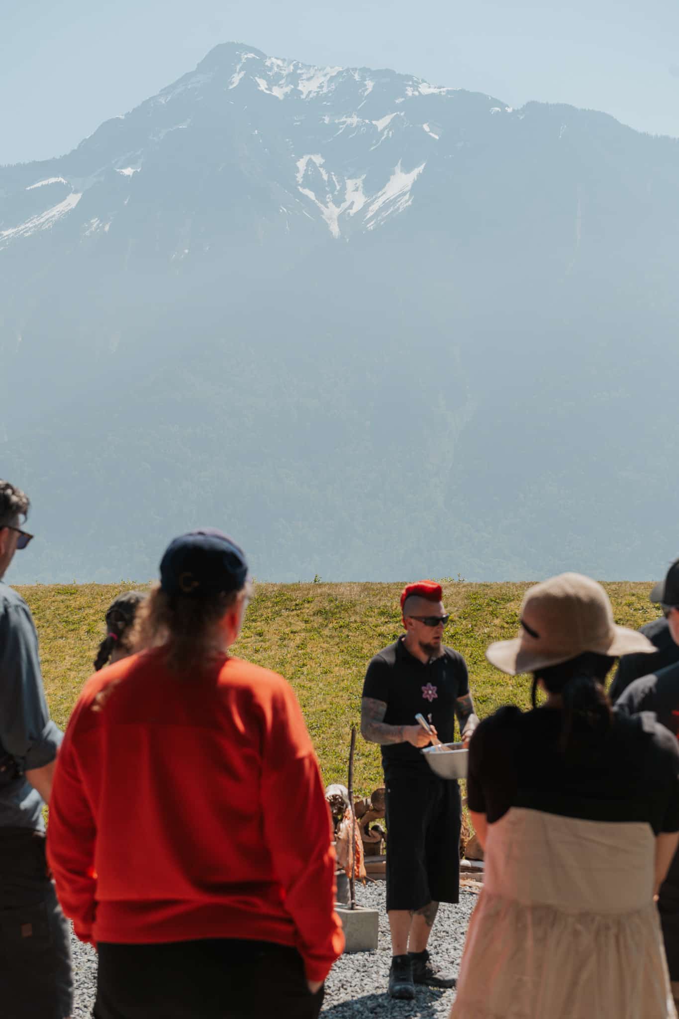 An indigenous man blessing a group of people