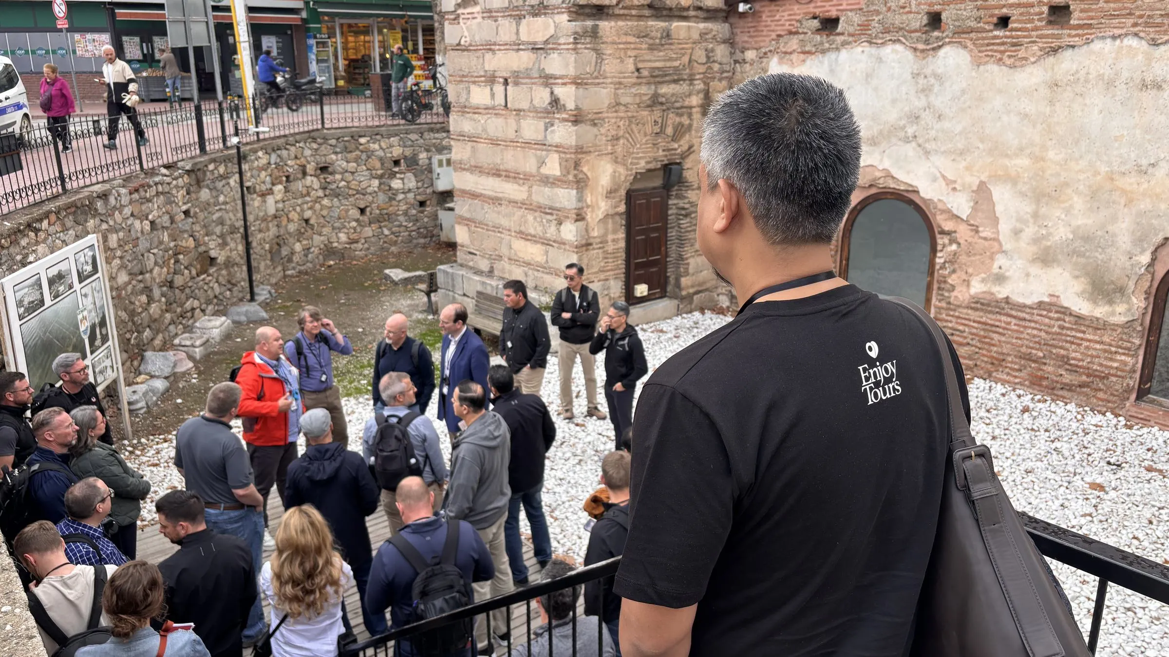 An Enjoy Tours guide talking with a group gathered around an excavated ancient site in the centre of Iznik, ancient Nicea