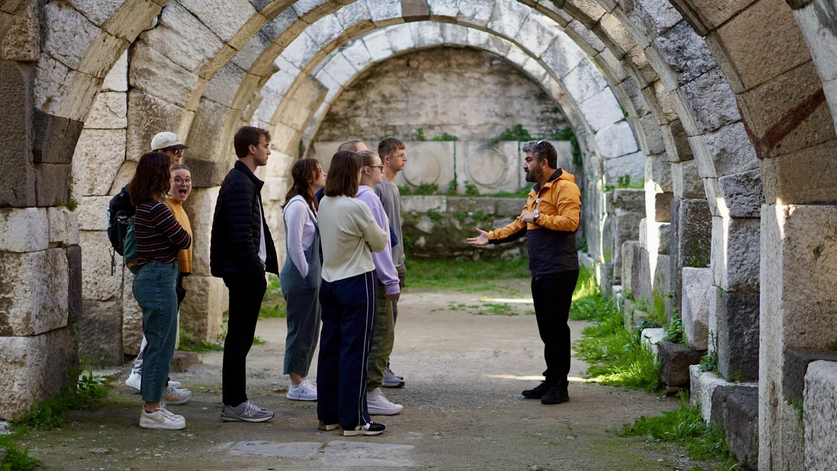 An Enjoy Tours group listening to their guide beneath the Roman arches of the agora in Smyrna