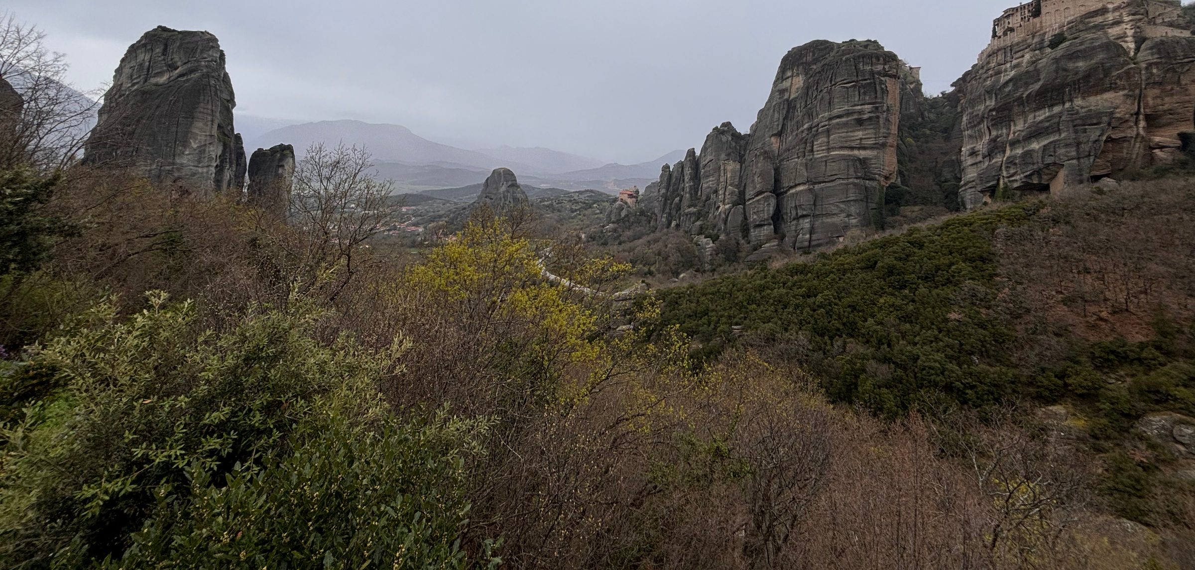 The rock towers of Meteora above the valley.