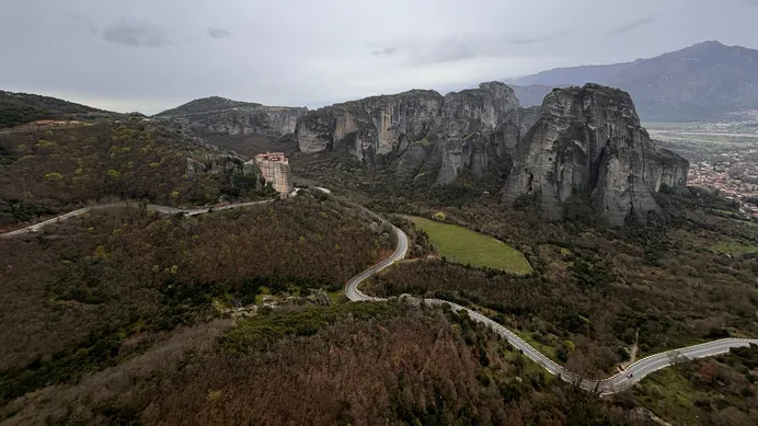 Monasteries perched on the sandstone pillars of Meteora, with the road winding below.
