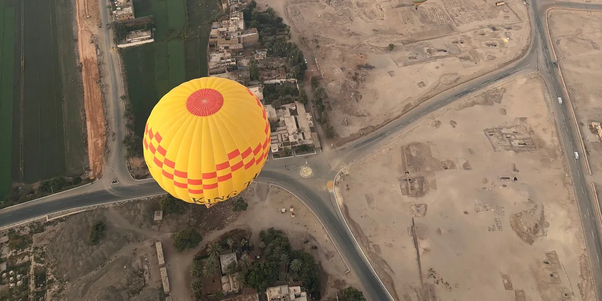 Balloons drifting over the Nile valley and the West Bank temples at Luxor.