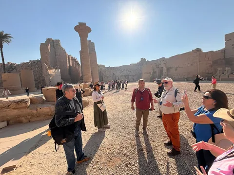 A guide teaching a group in the great court at Karnak.