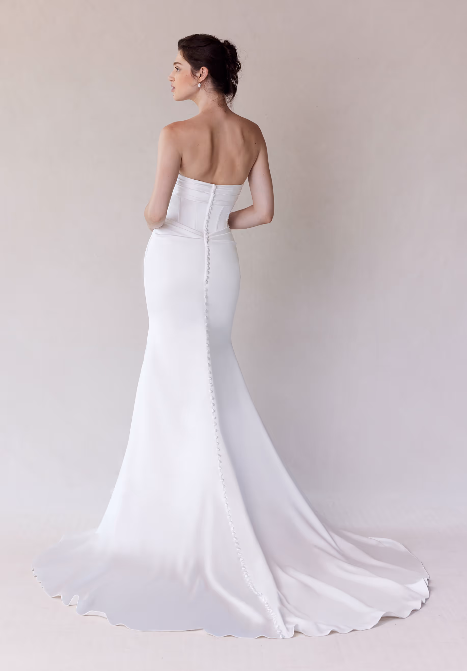 Elegant sheath wedding dress has corset boned bodice with a draped sweetheart neckline and detachable off-the-shoulder sleeves on a draped stretch satin skirt.