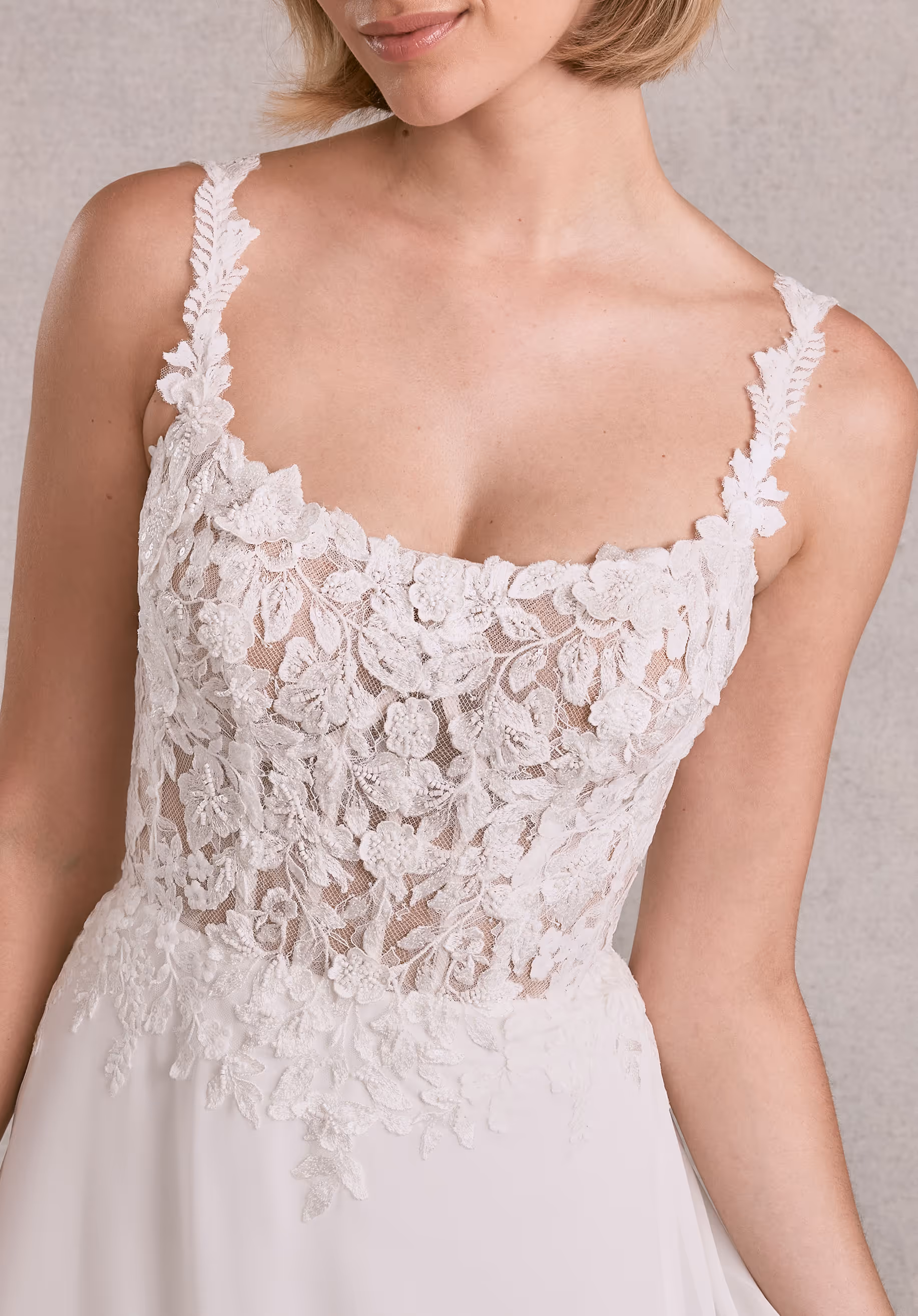 Effortless A-line has a a sheer boned bodice with beaded embroidered 3D floral appliqués and a square neckline on chiffon skirt.