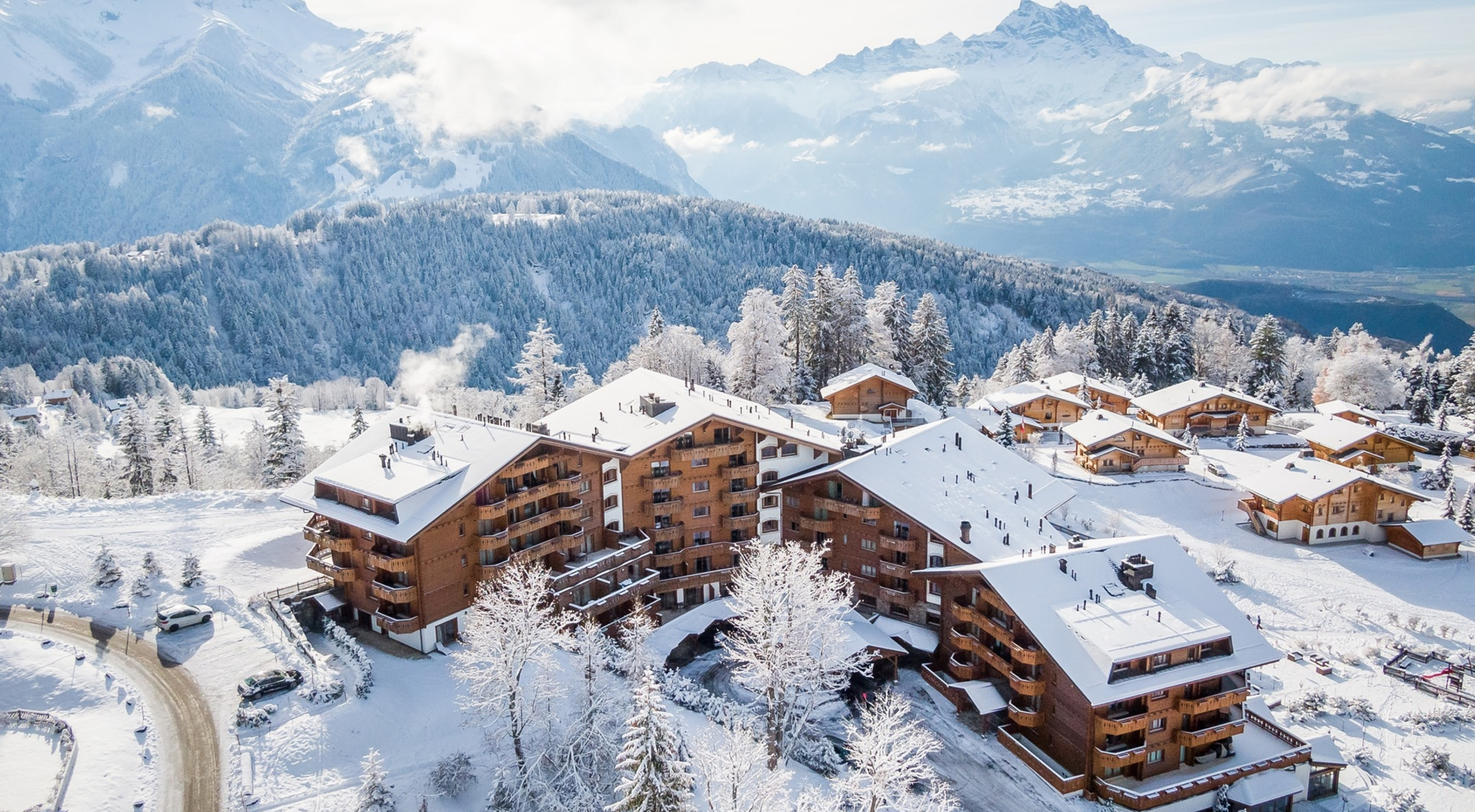 Exterior photo of the Chalet RoyAlp hotel amid the snow-covered Swiss Alps
