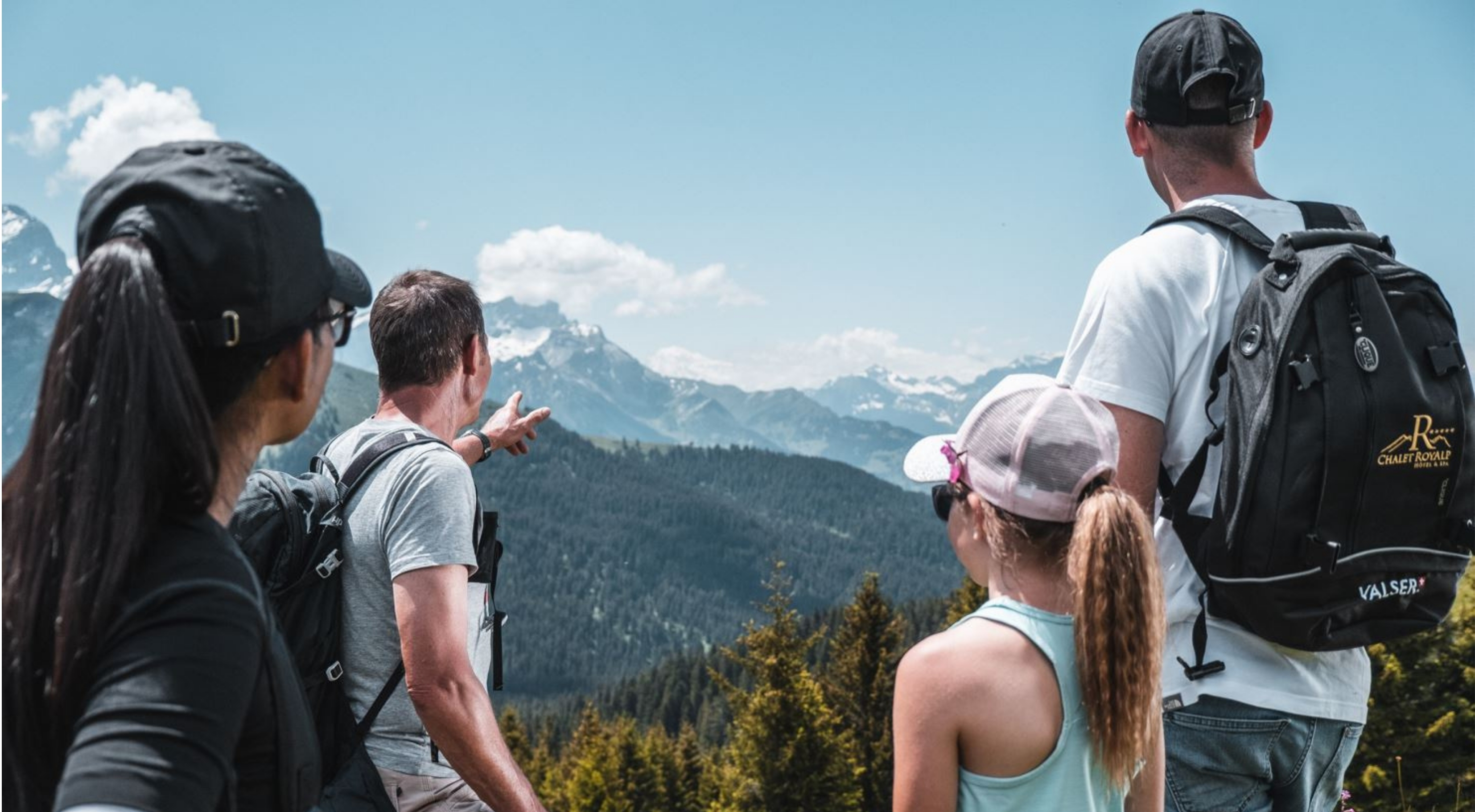 Family hiking in the Swiss Alps in fine weather