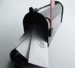 Close-up of a metal spout pouring white liquid into a container.