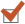 Orange check mark inside a white square checkbox.
