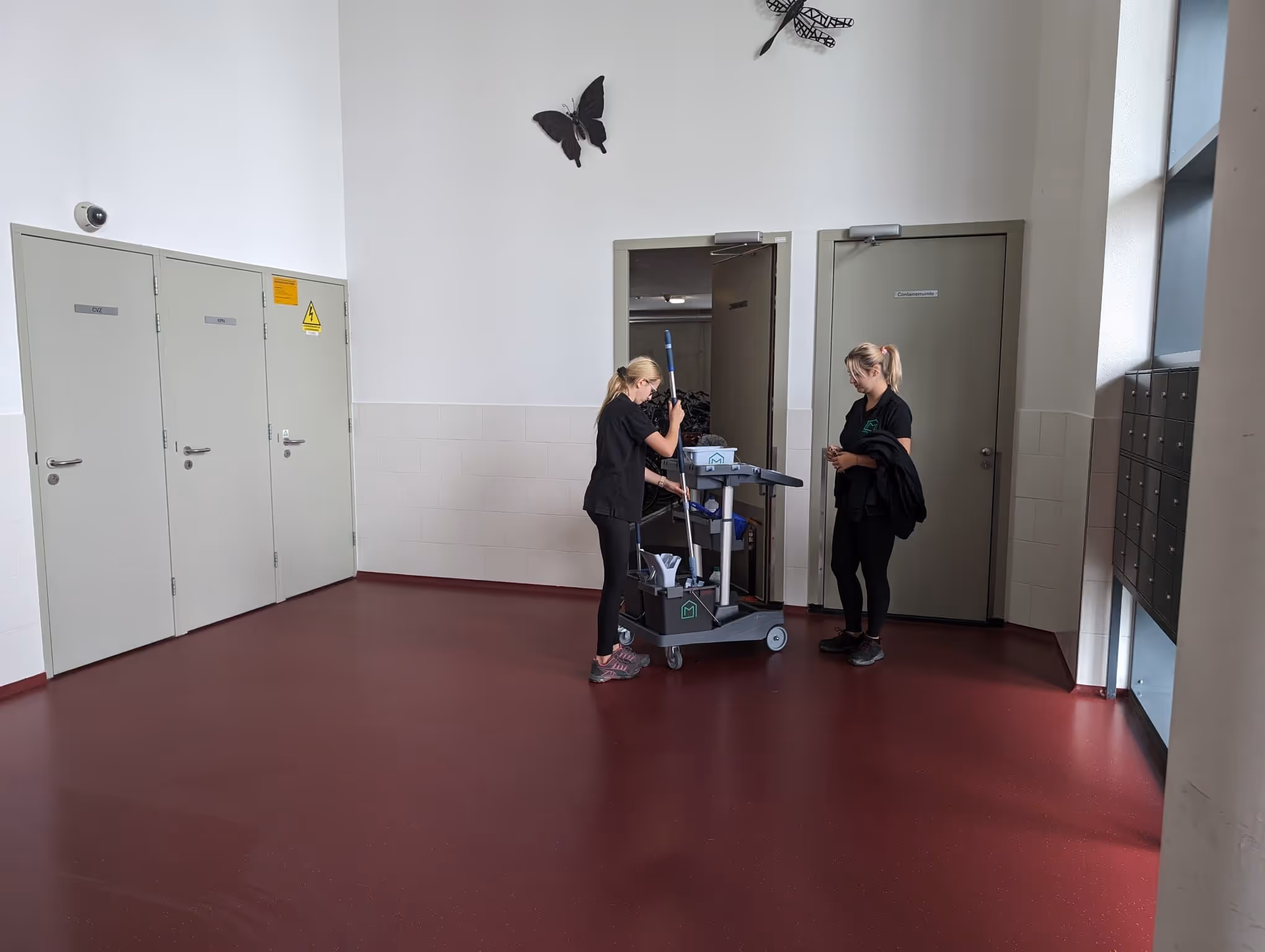 two professional cleaners placing equipment back