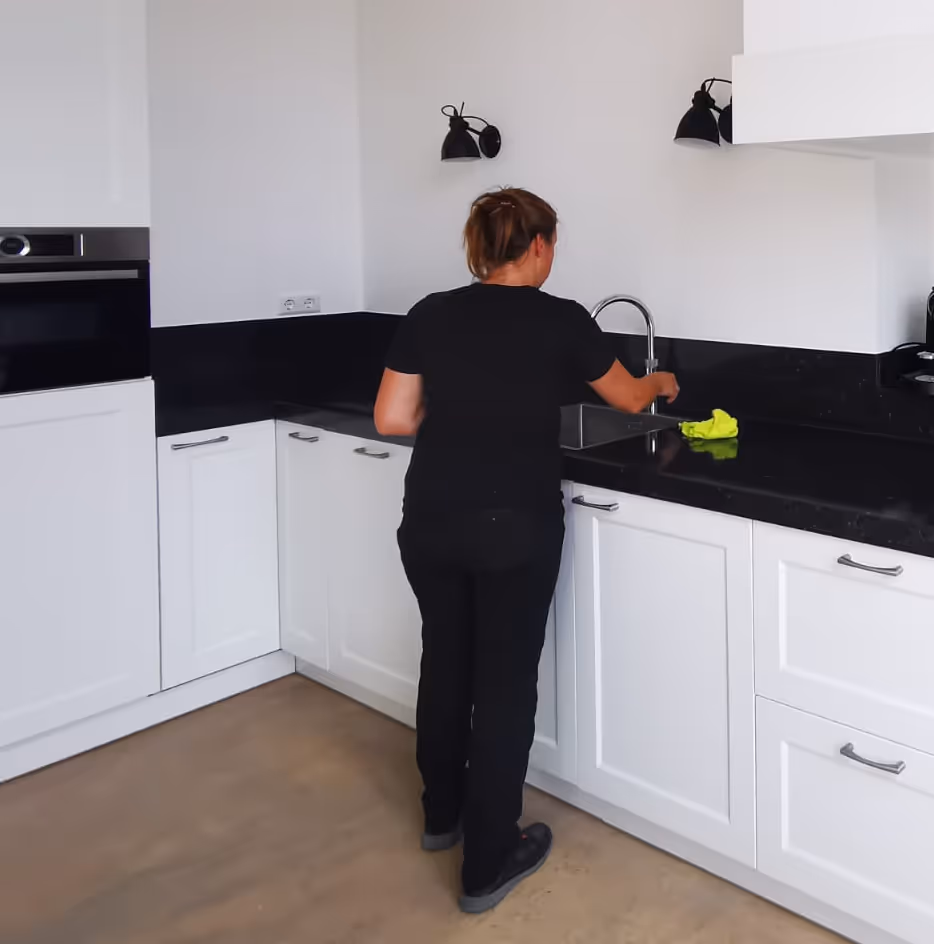 a professional cleaner cleaning a kitchen