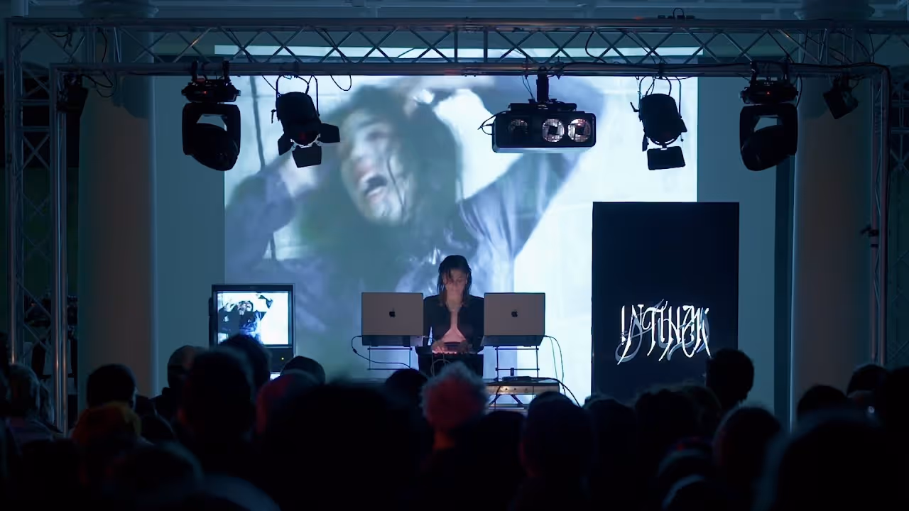 A DJ playing in front of a crowd