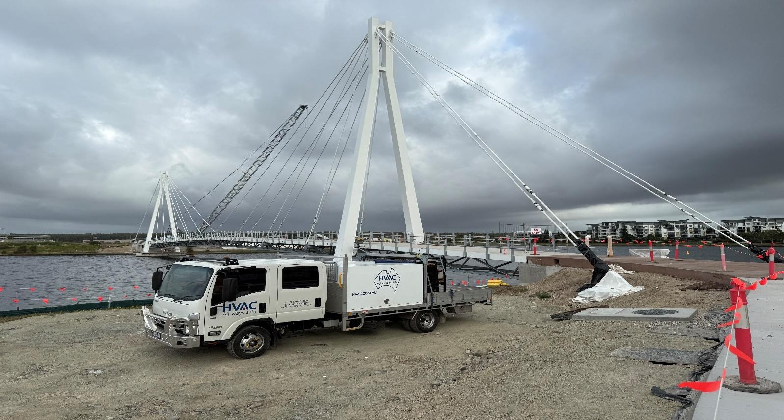 A truck on a road under a bridgeAI-generated content may be incorrect.