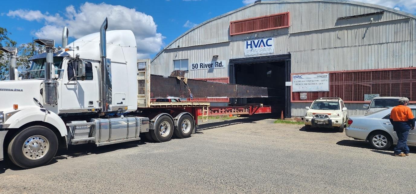 A truck loading a trailerDescription automatically generated with medium confidence