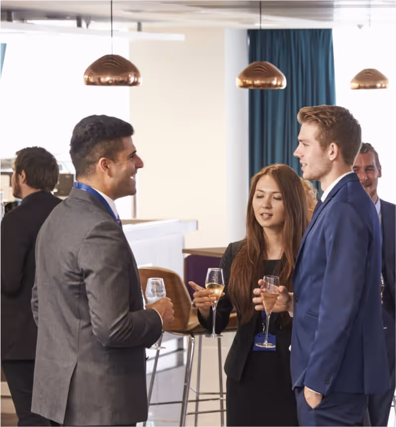 Professionals networking at business event in hallway