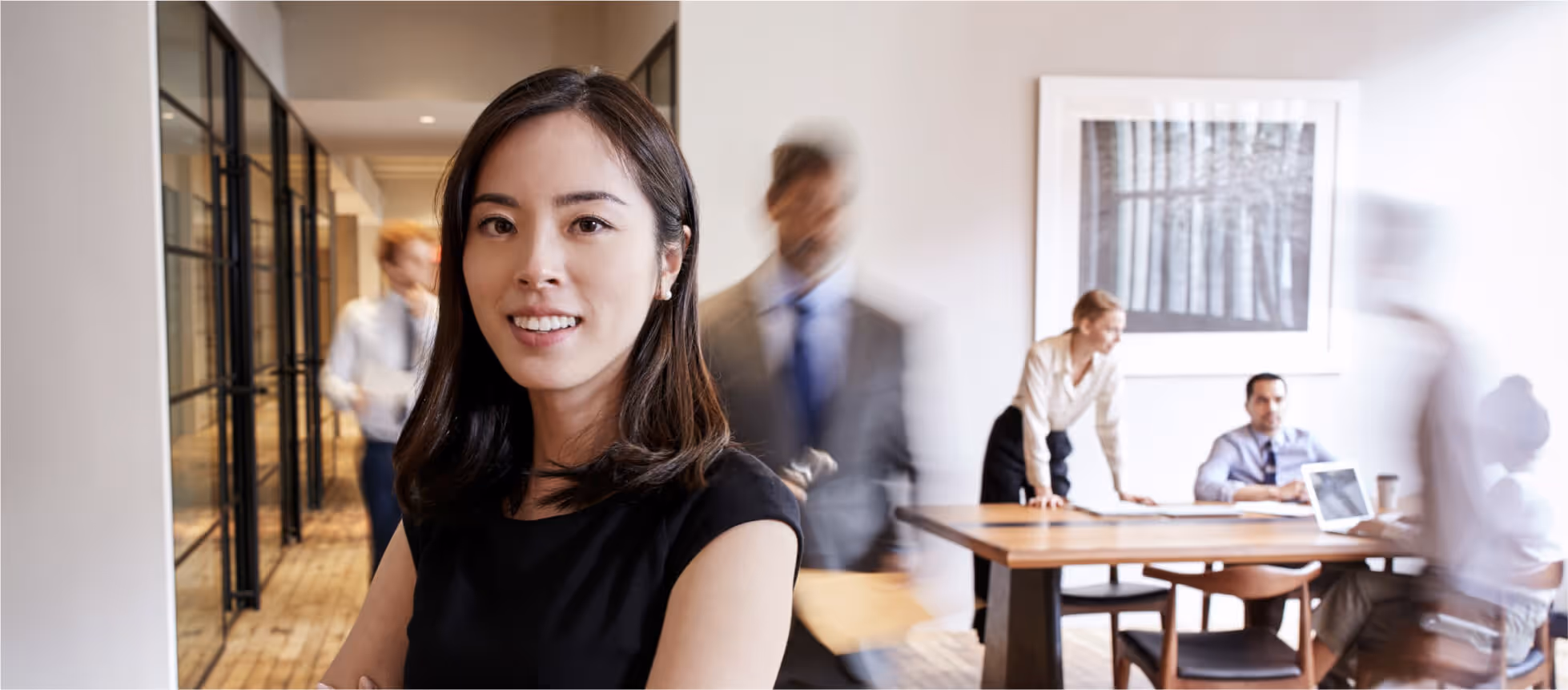 Smiling professionals in office meeting, hero banner style