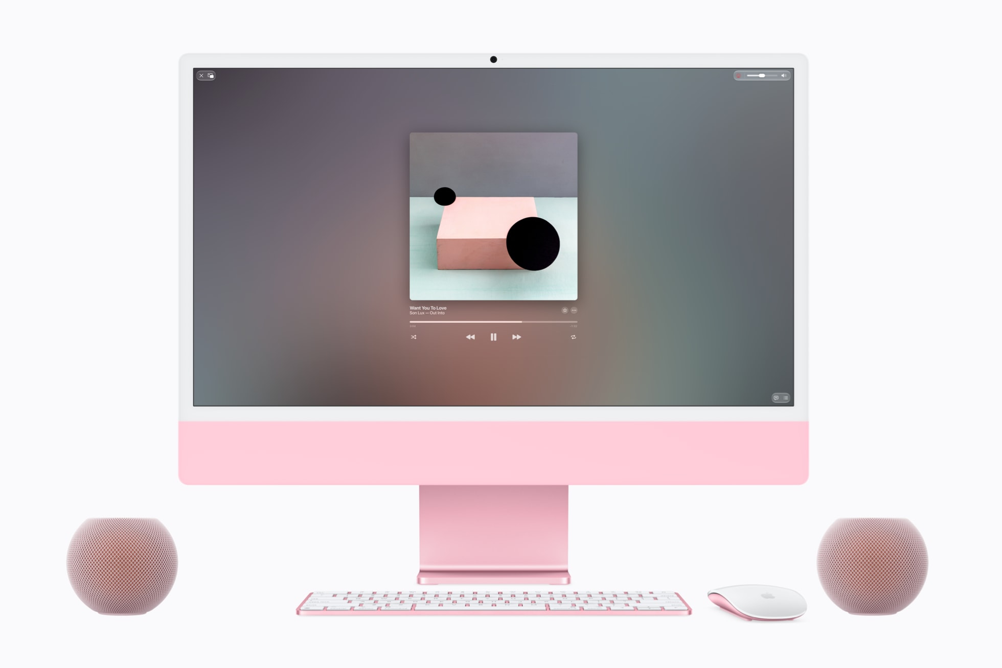 Apple HomePod mini 2 – två högtalare i rosa bredvid en iMac, framifrån