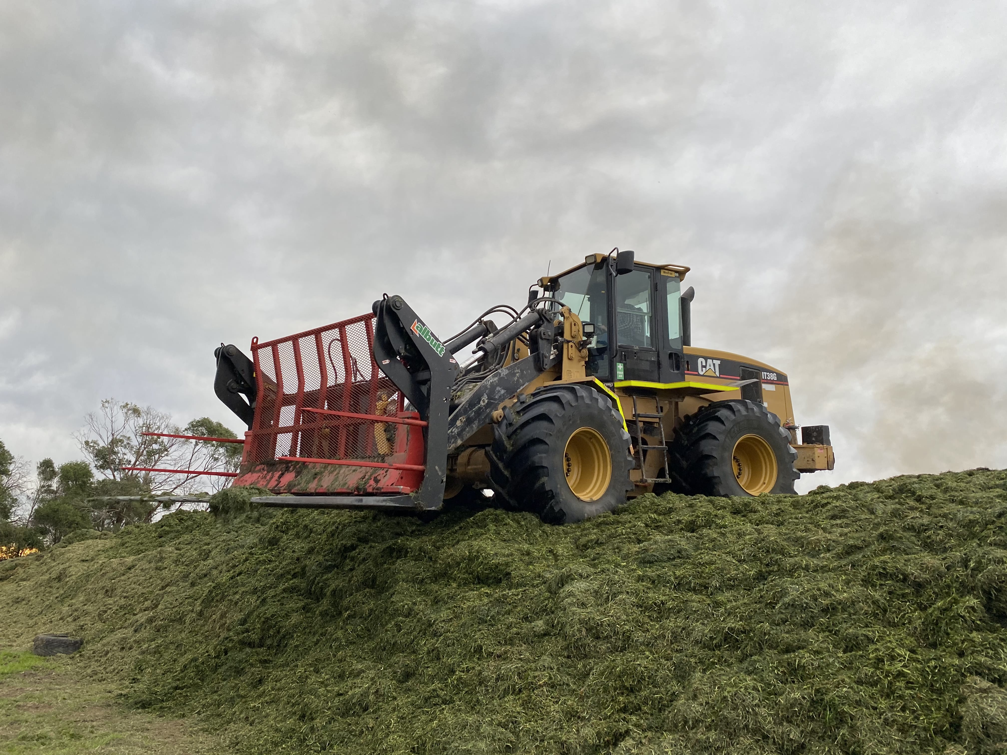 loader rolling silage pit