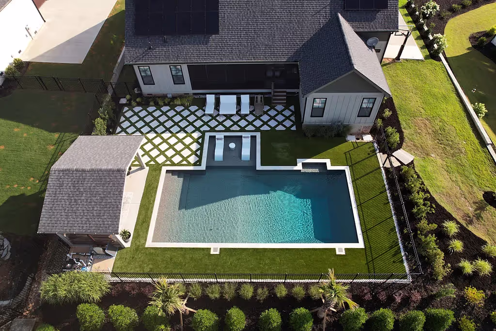 Backyard with turf and pool.