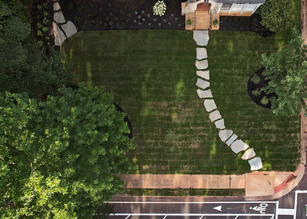 Drone picture of a front yard with pavers going from the front door to the sidewalk.