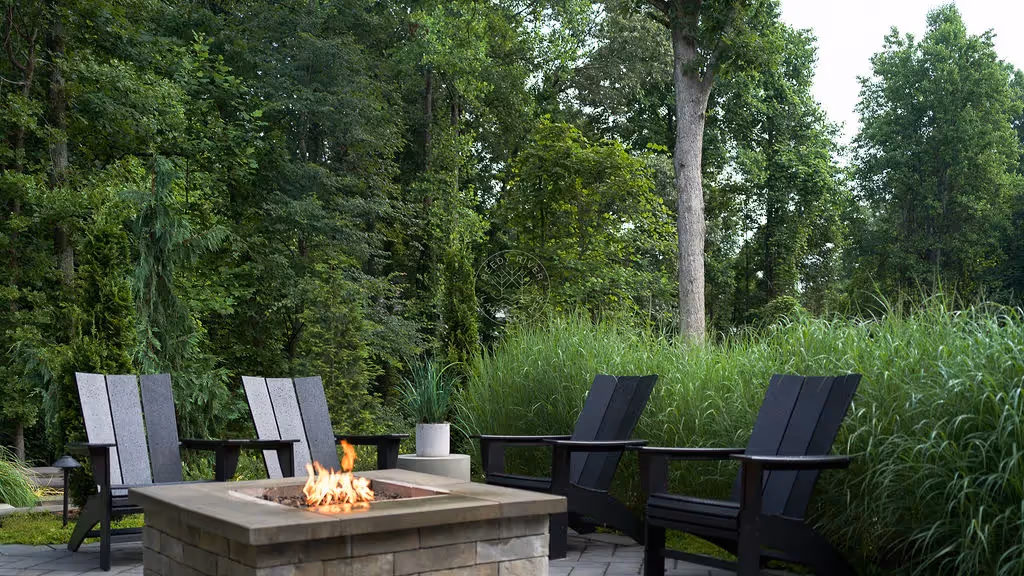 Outdoor gas firepit surrounded by chairs