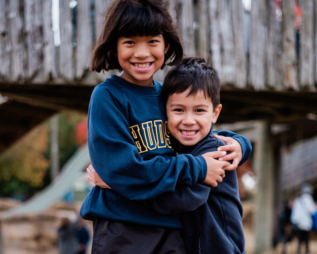 A smiling kindergarten child with blocks