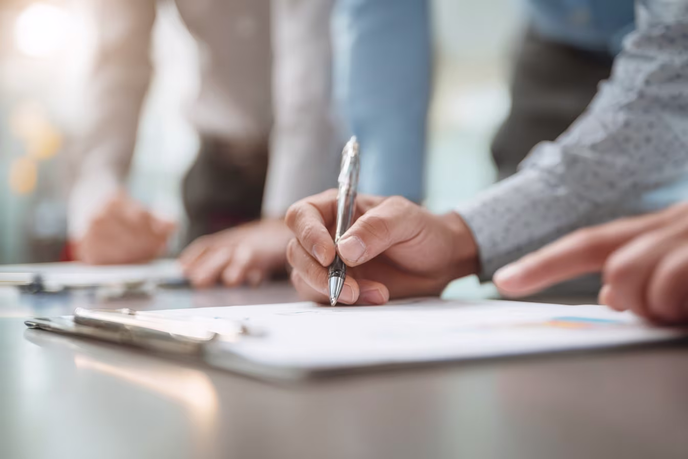 Team collaborating on CMMC compliance checklist