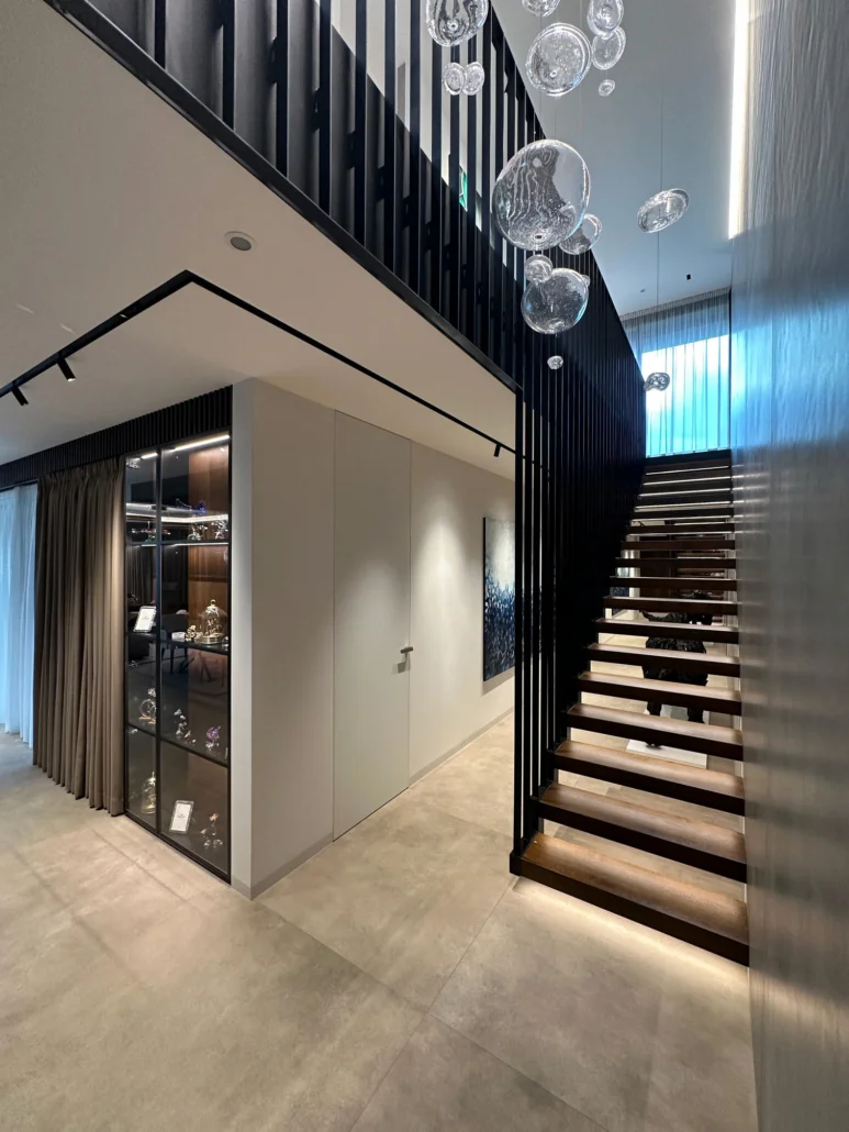 Fortius full height door installed flush with the wall (filomuro) in a hallway of a modern luxury residence.