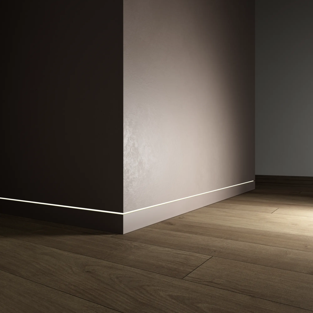 Dorsis Linus flush baseboard with LED strip lighting channel, flush base trim moulding painted the same dark color as the wall.