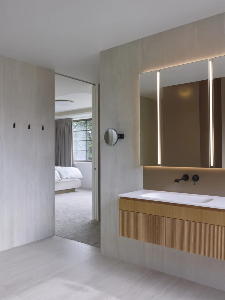 Floor-to-ceiling Belport pocket door, between luxury master bathroom and master bedroom.