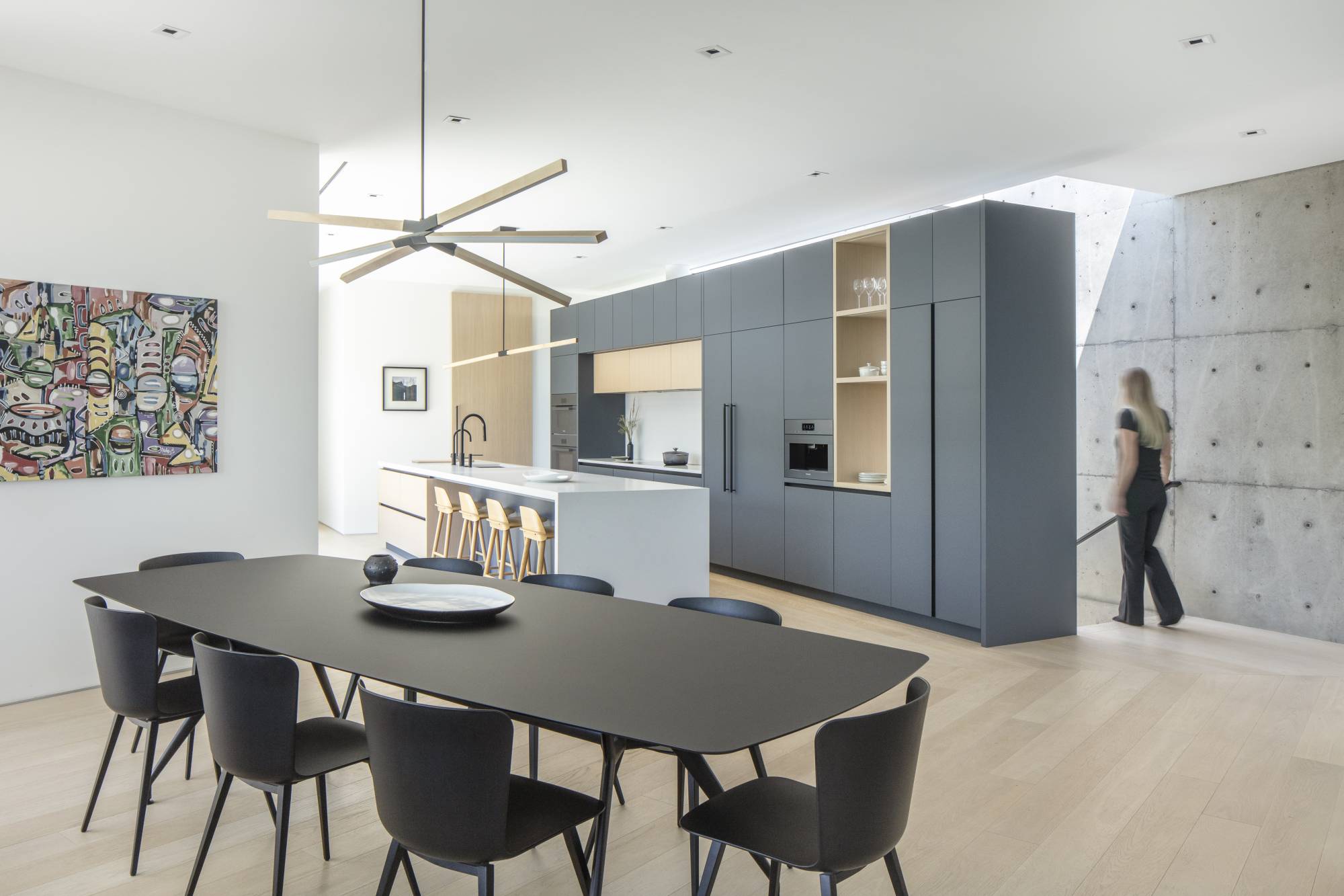 Barnero tall modern barn door in white oak veneer. Gray oak full-height kitchen.