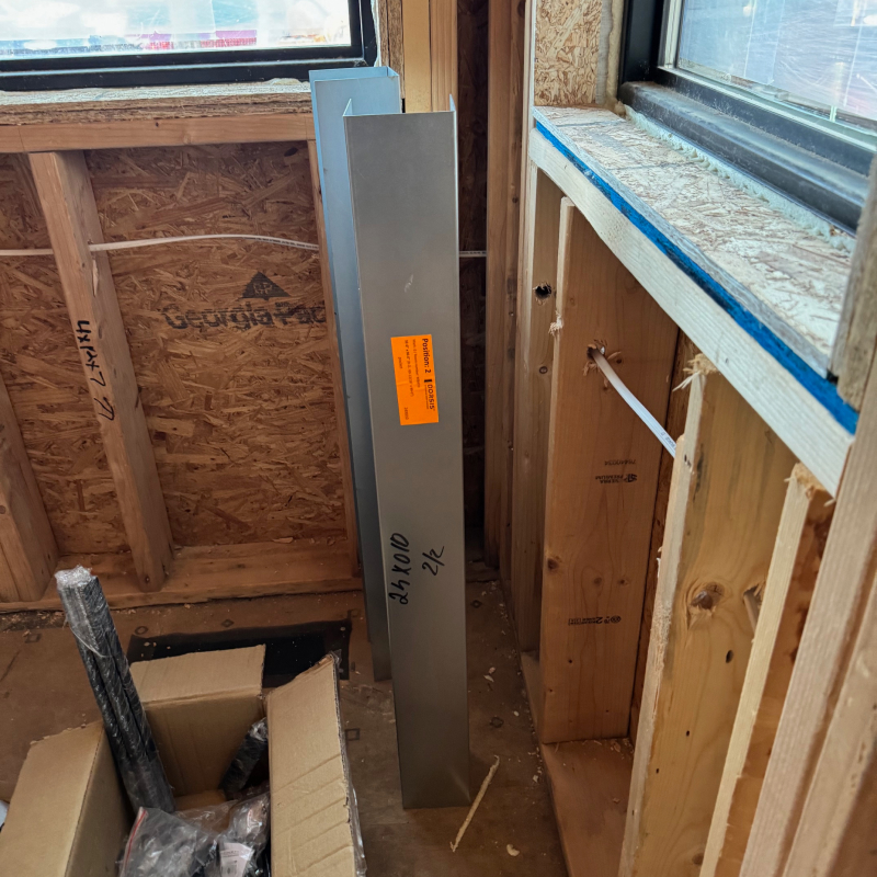 Dorsis Bottom Track Guard for Belport trimless pocket door. U-shaped steel channel. Construction site.
