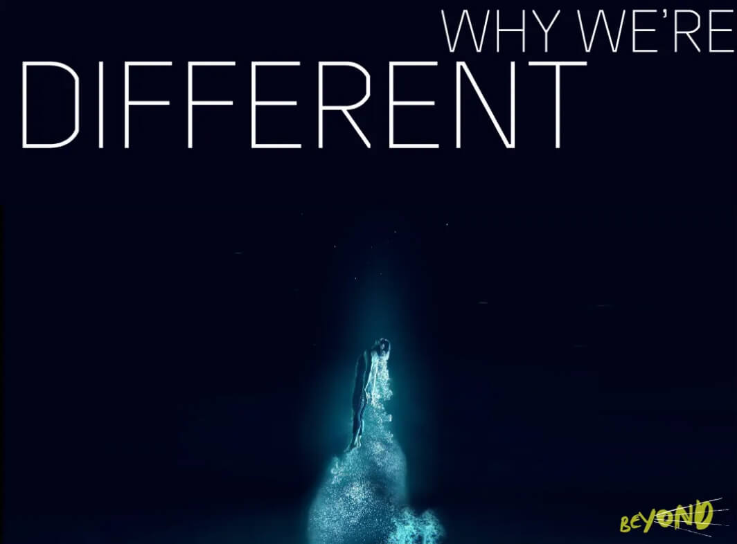 Silhouette of a person glowing with blue light rising upwards on a dark background with text 'WHY WE’RE DIFFERENT' and 'BEYOND' in yellow.