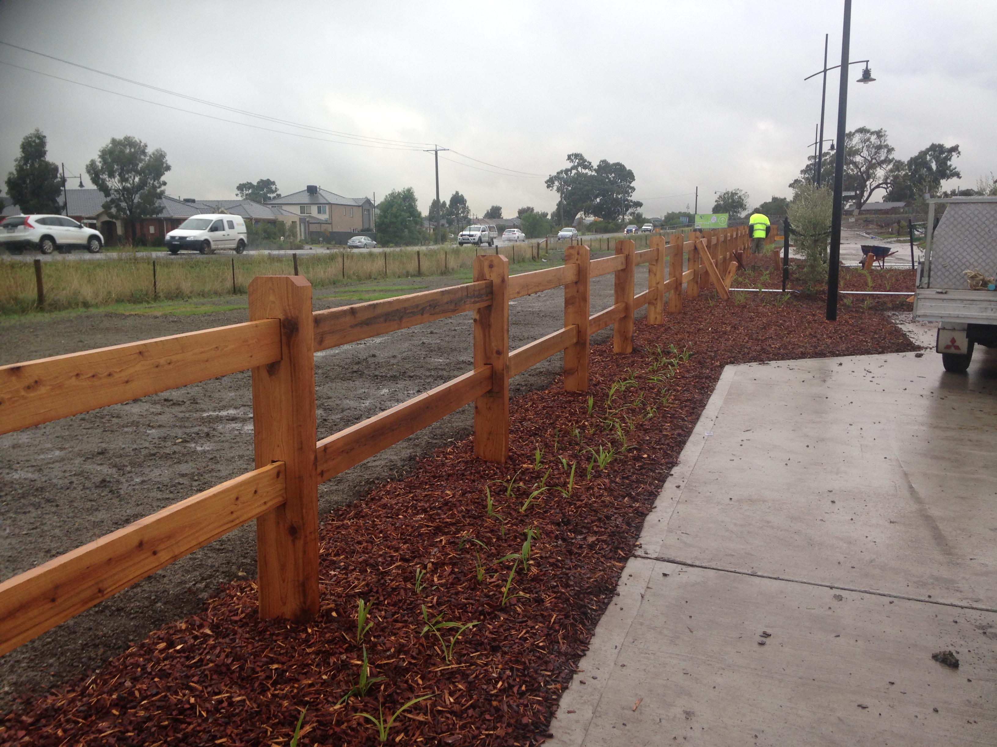 Image of a two rail cypress pine post and rail face being installed in Wollert