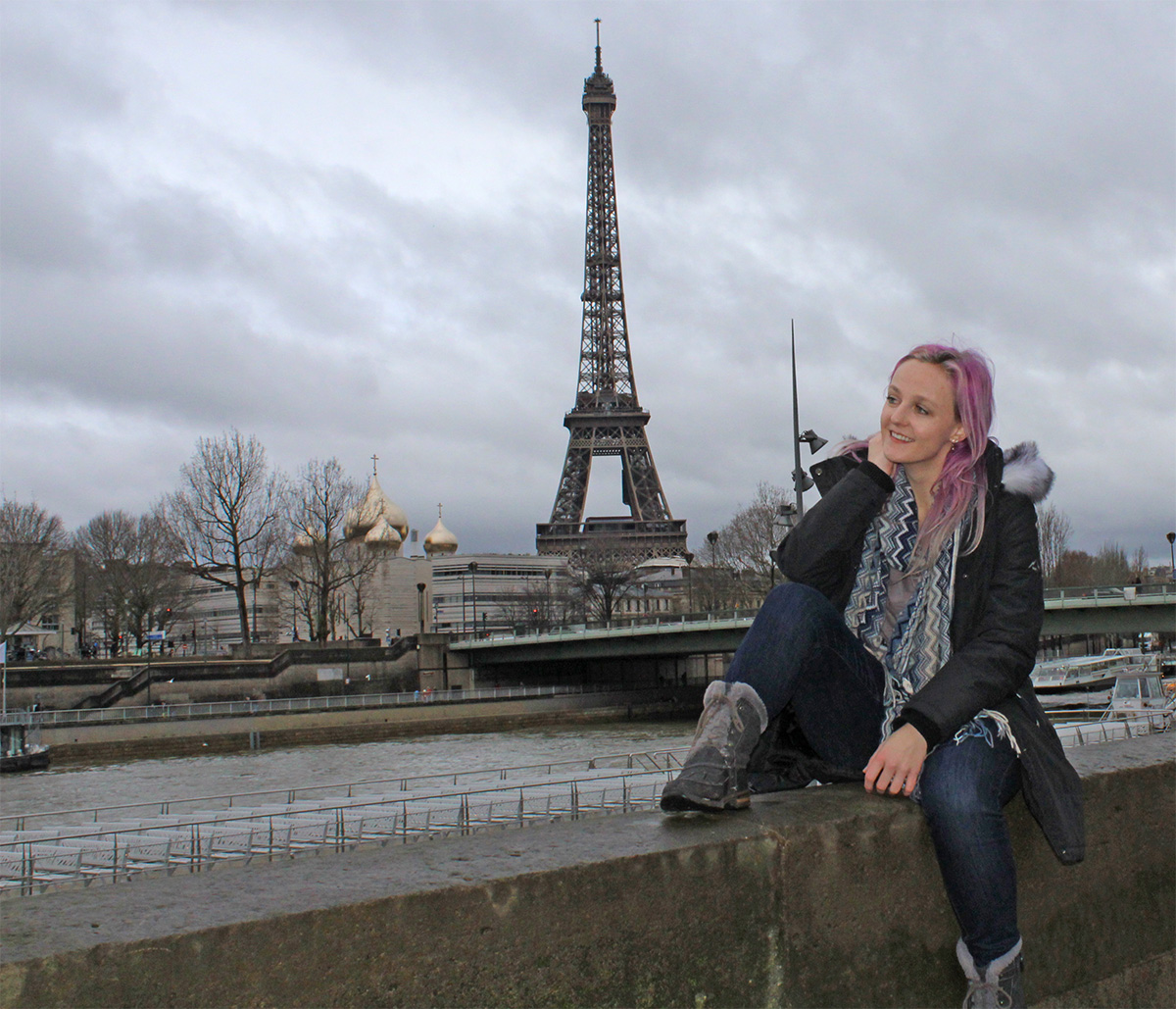 Myself sitting in front of the Eiffel tower in Paris.