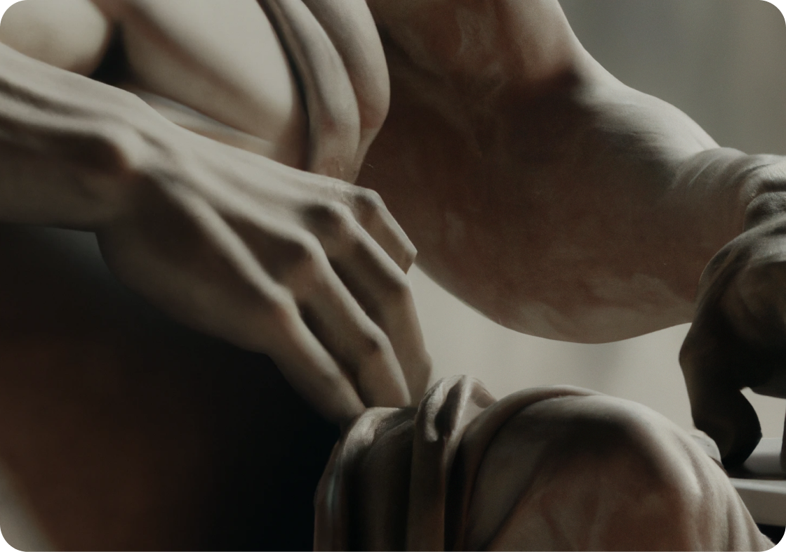 Close-up image of the statue of Michelangelo's David using a laptop