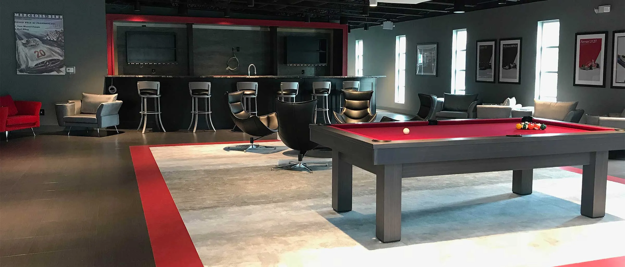 red pool table in a red and black themed room