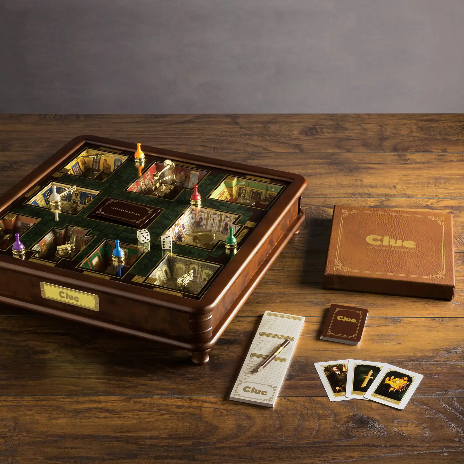 Exquisite luxury Clue board game set featuring a dark wood cabinet with a glass top, dimensional game board, and leather-bound notepad.