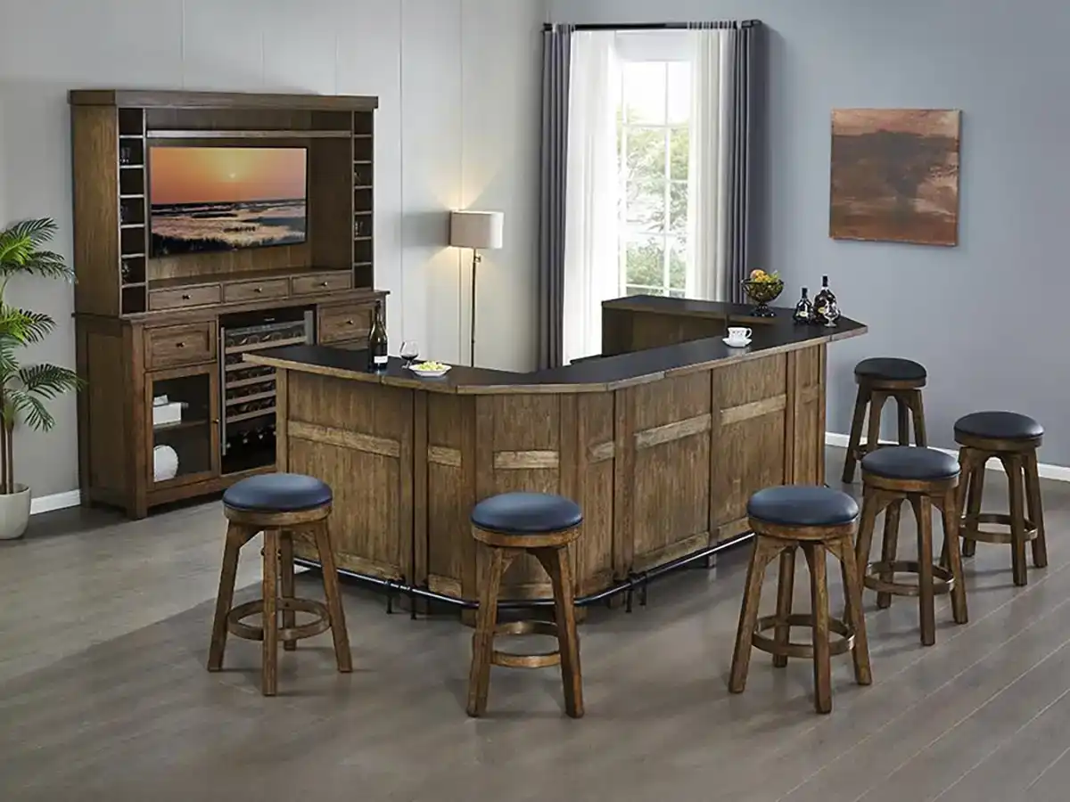 Large wooden home bar set with an L-shaped counter, backbar hutch with TV mount, wine cooler, and matching dark padded swivel bar stools.