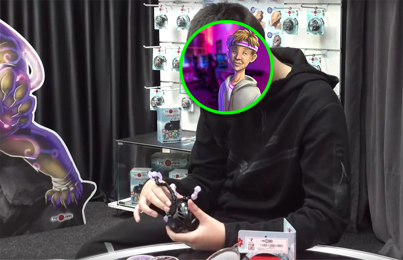 Photo of a young boy handling a Temari mech while sat at a table. His face is covered by a circular W8UP avatar.