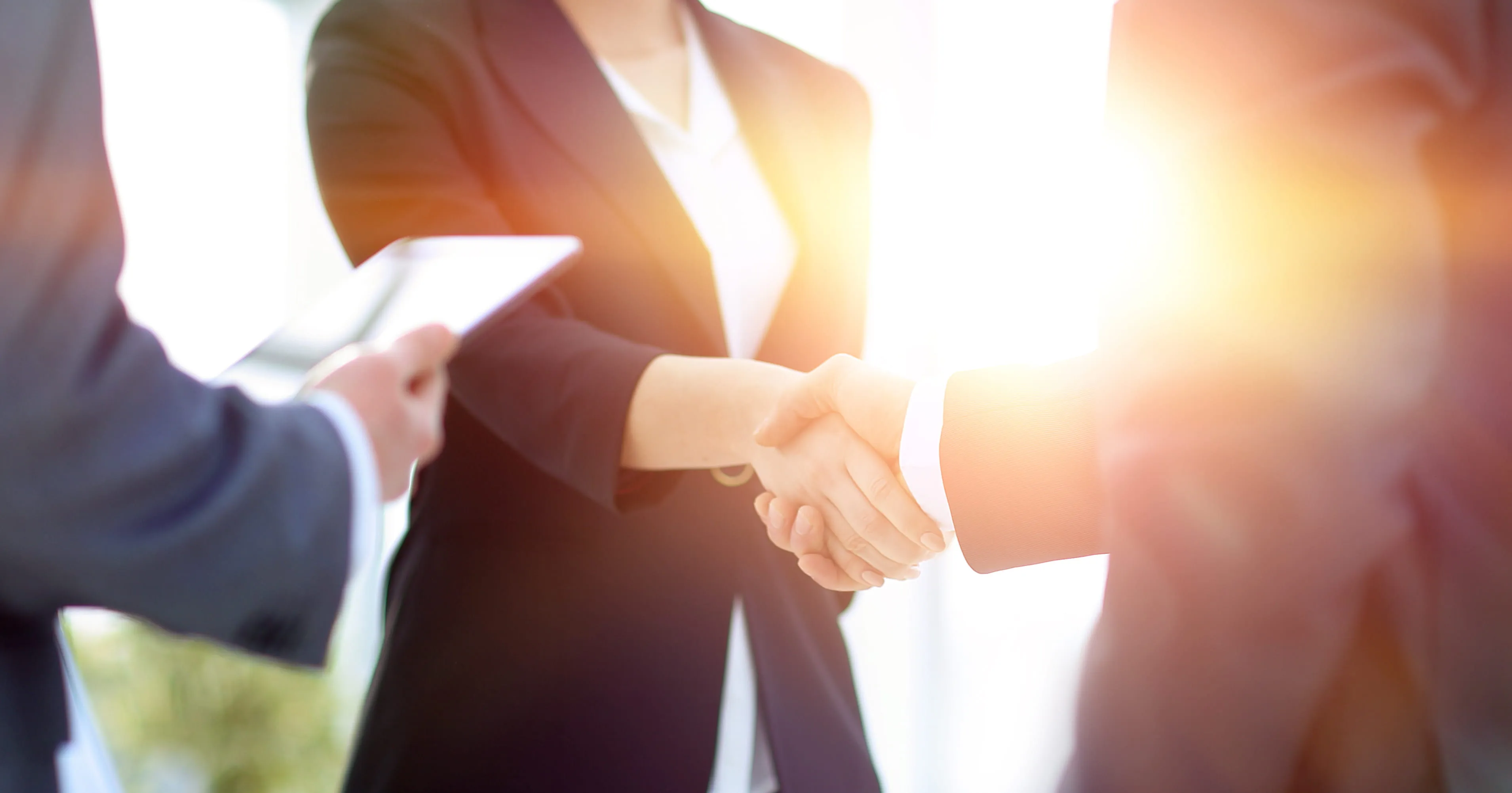 A close up of two people shaking hands