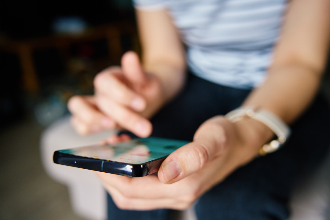 Woman using her phone to scroll