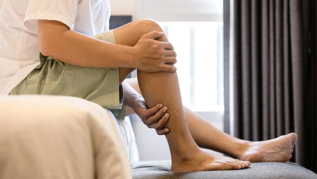 UK Vein Clinic - Man holding sore leg