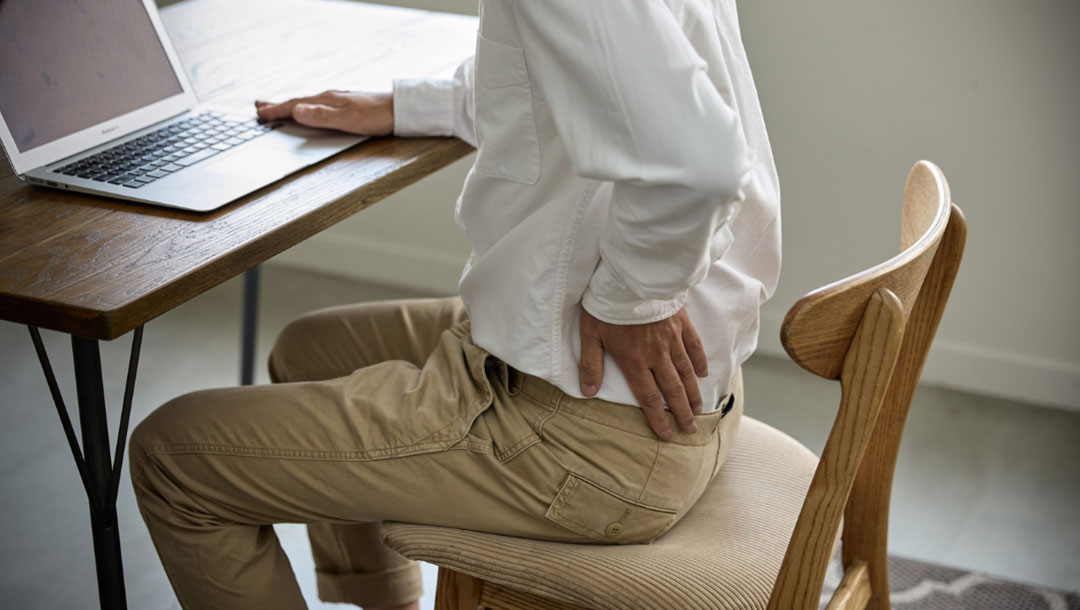 UK Vein Clinic - Man with backpain