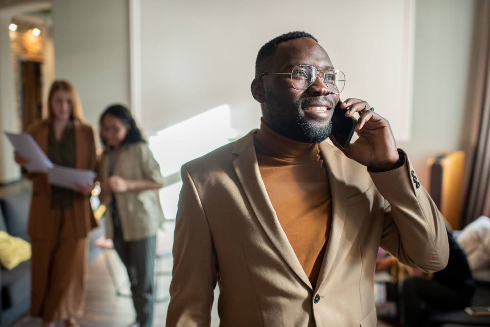 Prospect listening to sales pitch over the phone with positive expression