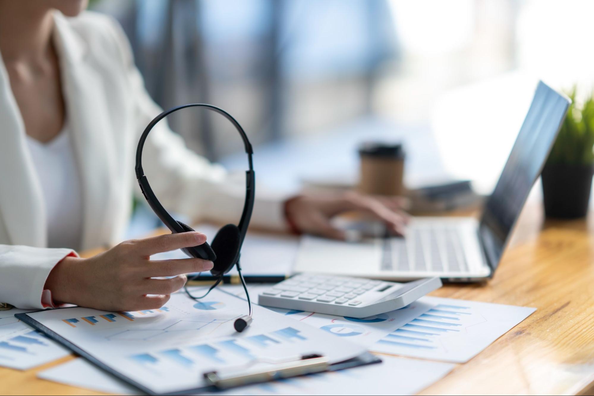 Agent removing headset between calls while juggling tedious manual follow-up tasks