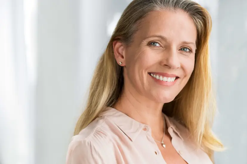 Woman with a full, confident smile, representing dental implants in Staten Island