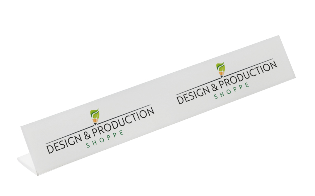 White triangular display sign with the logo and text 'Design & Production Shoppe' featuring a green and orange leaf and pencil icon.