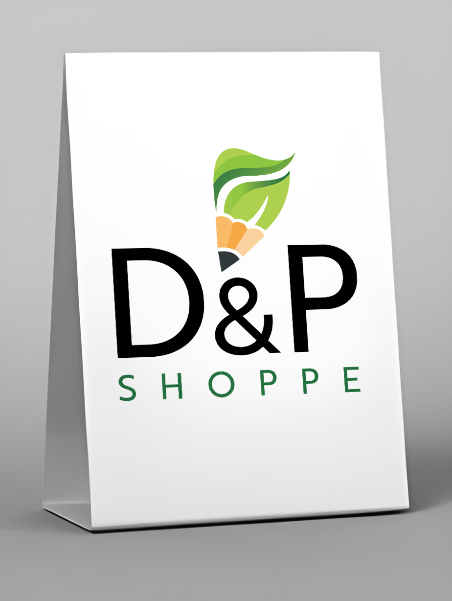 Tent card with logo featuring stylized green leaf and pencil tip above large black letters 'D&P' and green text 'SHOPPE'.